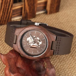 Mechanical wooden watch oblique side view with stitched leather band, walnut case, and visible gearwork dial design