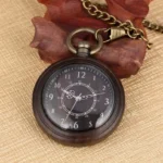 Vintage wooden steampunk pocket watch with dark brown wood case and bronze stainless steel hardware, displaying black analog dial with Arabic numerals, shown against linen fabric with wooden props